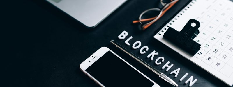 Free Flat lay of a modern digital workspace with blockchain theme, featuring a smartphone and calendar. Stock Photo